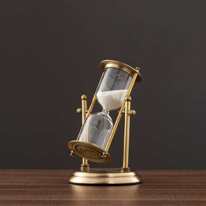 Skorter | Antique hourglass made of brass with violet sand
