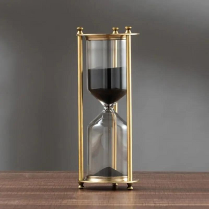 Skorter | Antique hourglass made of brass with violet sand