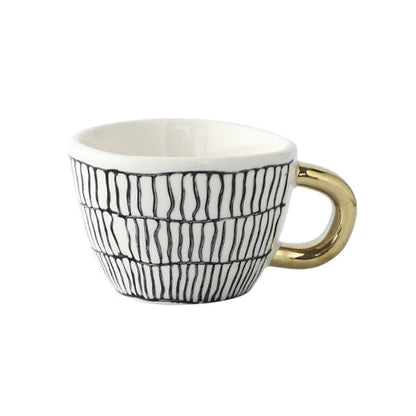 Skorter | Cup with abstract geometric pattern and gold handle