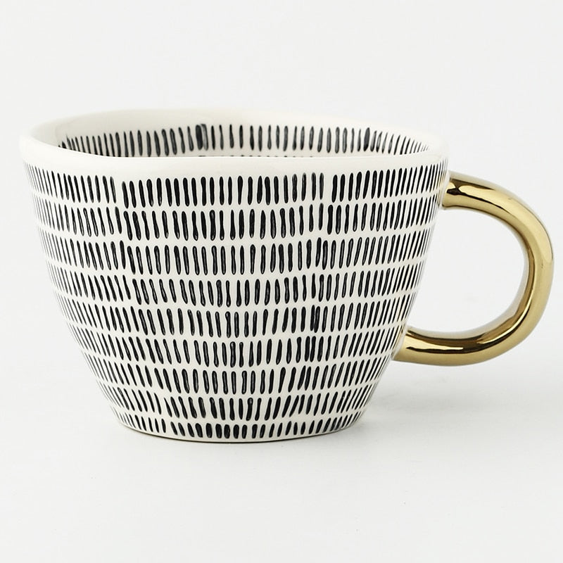 Skorter | Cup with abstract geometric pattern and gold handle