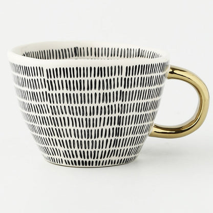Skorter | Cup with abstract geometric pattern and gold handle