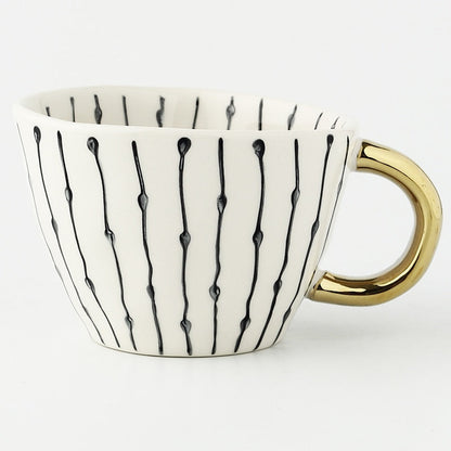 Skorter | Cup with abstract geometric pattern and gold handle