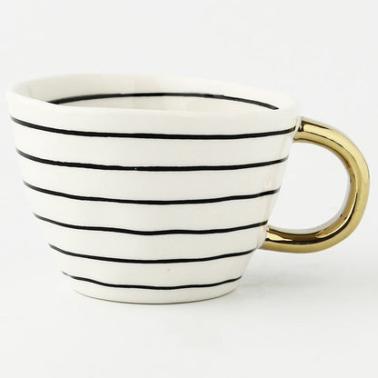Skorter | Cup with abstract geometric pattern and gold handle