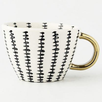 Skorter | Cup with abstract geometric pattern and gold handle