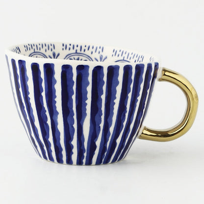 Skorter | Cup with abstract geometric pattern and gold handle