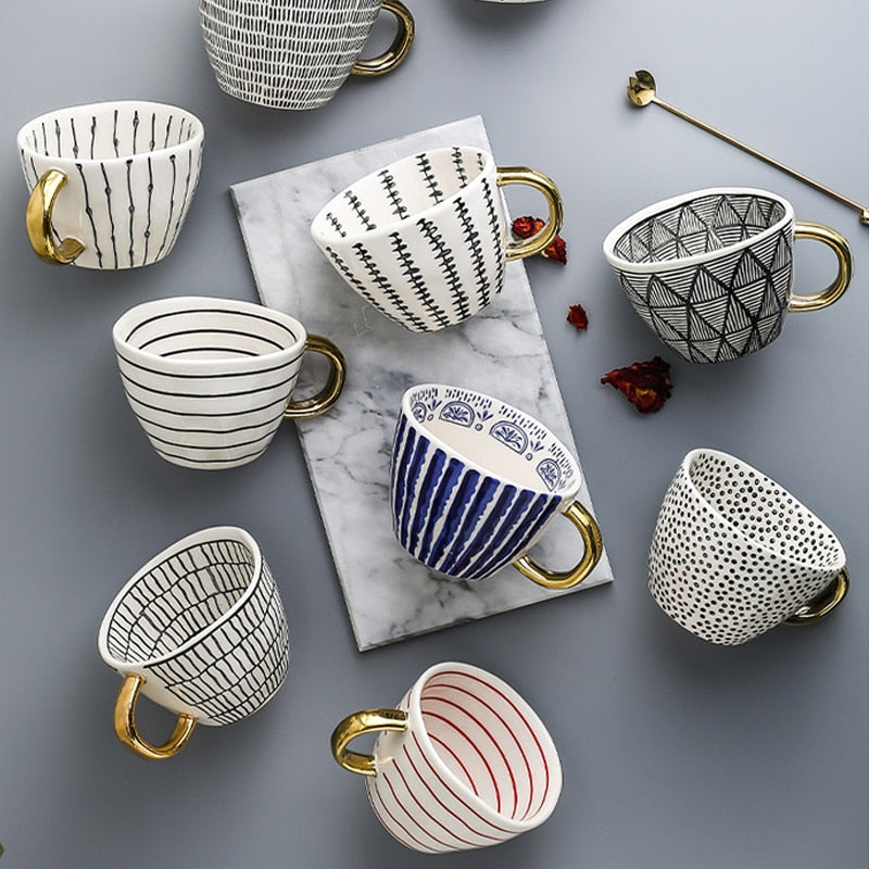 Skorter | Cup with abstract geometric pattern and gold handle