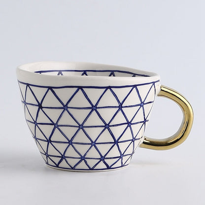 Skorter | Cup with abstract geometric pattern and gold handle