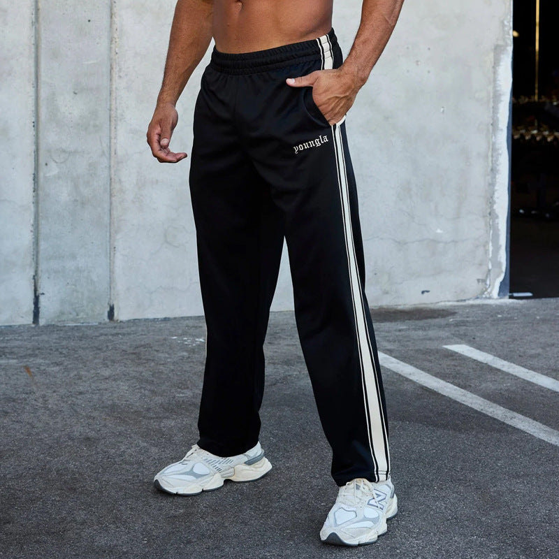 Men's sporty jogging pants with side contrast stripes and elastic waistband Skorter