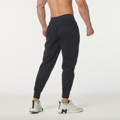 Men's sporty sweatpants with elastic waistband and side zip pockets Skorter