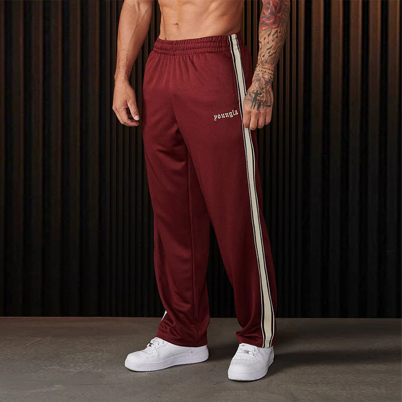 Men's sporty jogging pants with side contrast stripes and elastic waistband Skorter