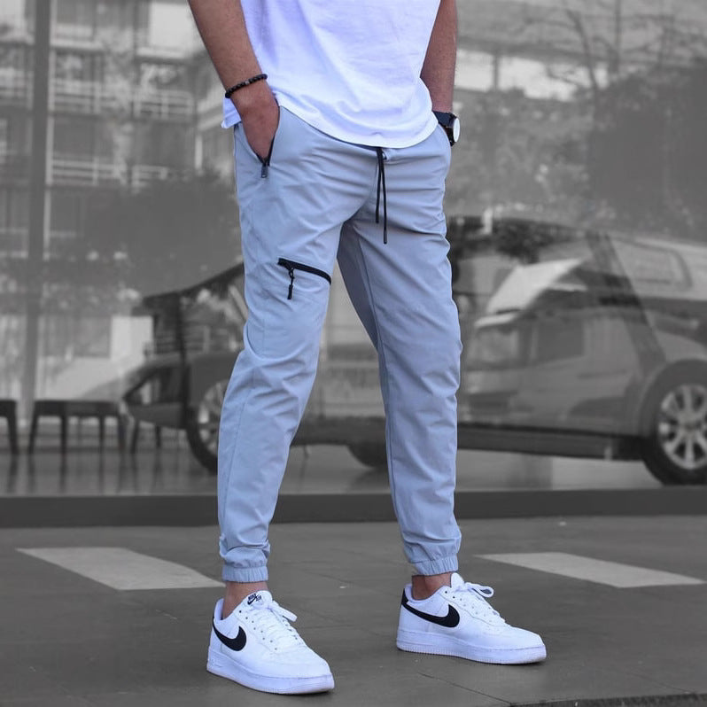 Men's sporty suit pants with elastic waistband and side zip pockets Skorter