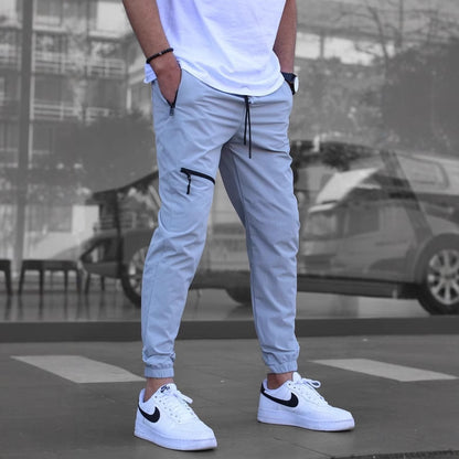 Men's sporty suit pants with elastic waistband and side zip pockets Skorter