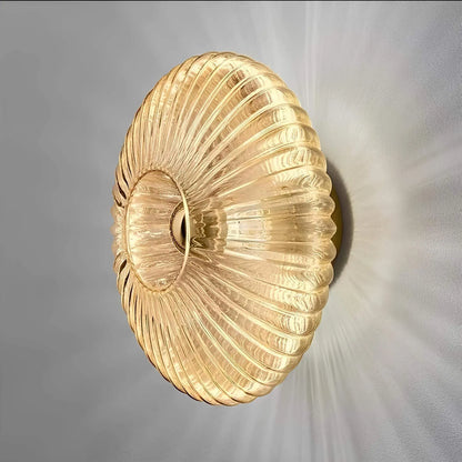 Skorter | – Vägglampa i glas med vågigt ljus